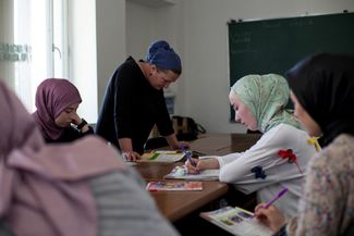 Students attend an intermediate English class at a school in Jokolo. June 2019.